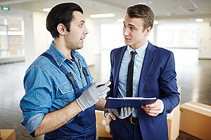 blue-collar-and-white-collar-worker.jpg websites Young businessman and relocation office staff discussing terms of agreement after making service